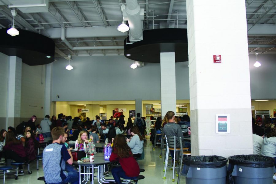 Students enjoy lunch in the newly updated cafeteria. The ceiling rafter were previously red before being painted as the senior gift. 