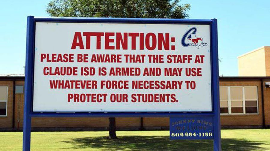 Posted sign at a high school to warn parents and students about armed teachers.