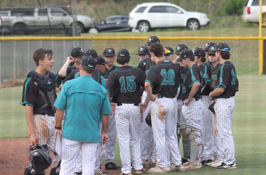 The+team+huddles+in+between+innings+during+a+state+playoff+game+versus+Ragsdale.+The+Raiders+won+6-0+against+the+Tigers+on+May+9.