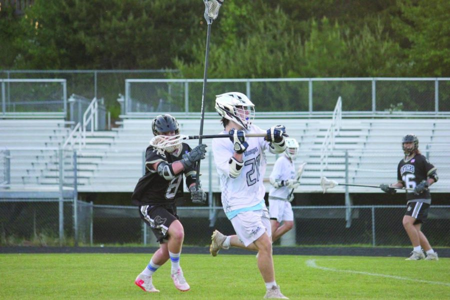 Senior+Mercer+Crouch+sets+up+to+pass+the+ball.+The+Reagan+mens+lacrosse+team+played+against+Providence+High+School+on+May+2+in+the+state+playoffs.+