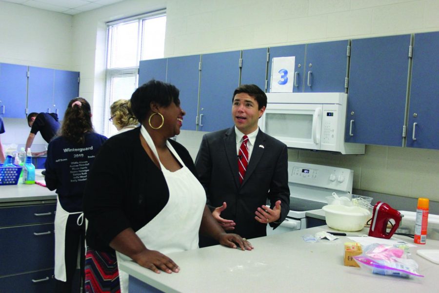 Johnson shares stories with Foods teacher Falisha McCloud. He had conversations with many students and faculty at Reagan.