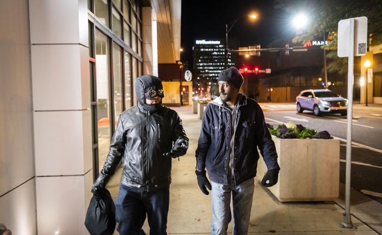 Nick Olsen. otherwise known as Night Watch walks with Joshua Temple to a homeless shelter. This is one of the ways he aids the homeless community in downtown Winston-Salem.

Photo courtesy of Andrew Dye