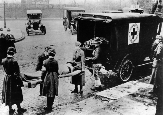 A Spanish flu victim is being carried by American Red Cross volunteers. The disease spread was prevalent, and its estimated that 20 to 100 million people were killed by it worldwide.