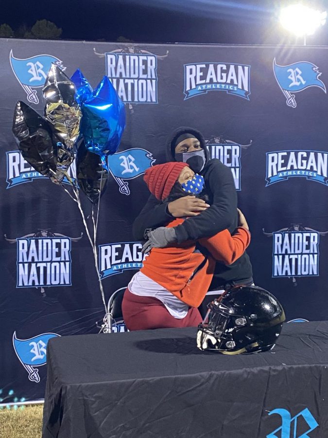 On a cold night, senior Tazhae Woods warmly embraces his mother after thanking her in his speech. Woods, both a wide receiver and cornerback, has committed to play for Iowa Western Community College 