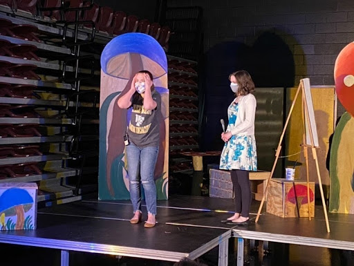 Actresses Elizabeth Gambill (12) and Alyssa Eaton (12) practice their lines at a dress rehearsal of “Alice in Wonderland.” The play will be performed in the bus lot of Reagan’s campus.