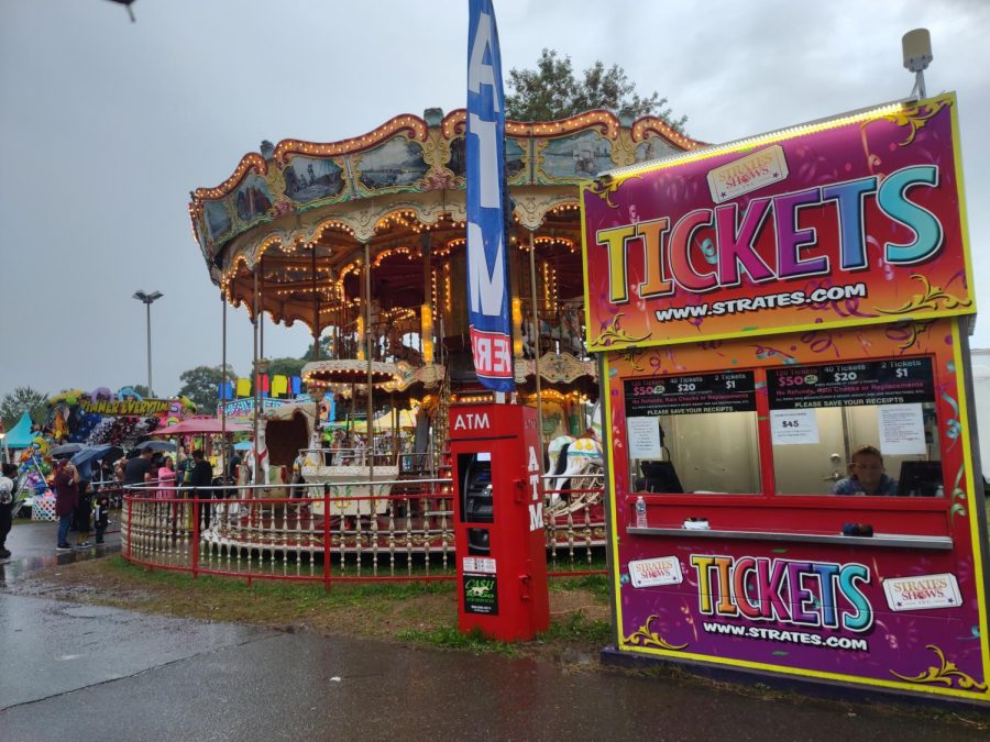 The Carolina Classic Fair has a ticket booth near the carousel. Despite gloomy weather conditions, fairgoers enjoyed fair rides and activities.
