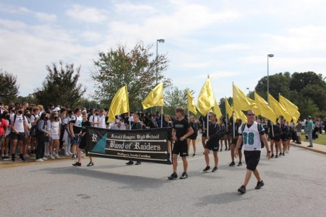 The Band of Raiders marches in the parade before the pep rally. They were followed by the cheerleaders and Raiderettes, school club representatives, and the homecoming queen candidates.