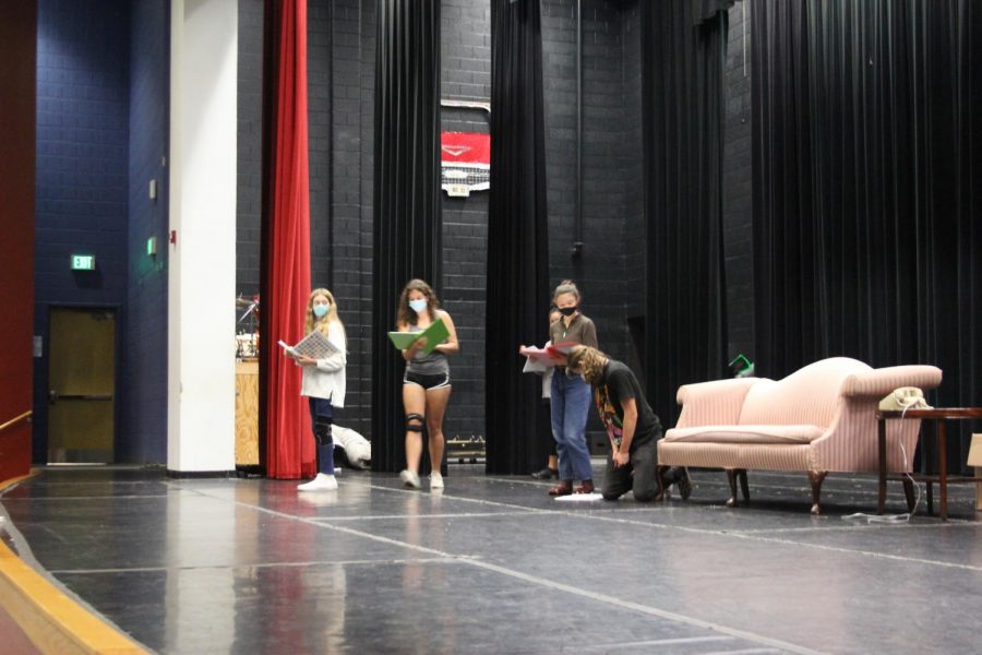Actors in cast one of “Noises Off” move around the stage, figuring out spacing of props and delivery of their lines. Actors felt nervous due to the time crunch that the production is under.