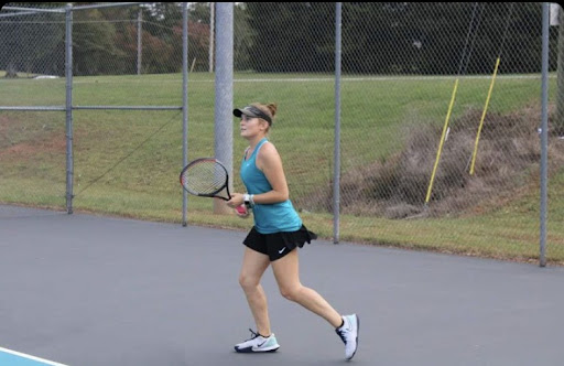 Senior Ashley Belnap plays in a singles match against Glenn on Oct 11. The Raiders went on to win with a 9-0 score.