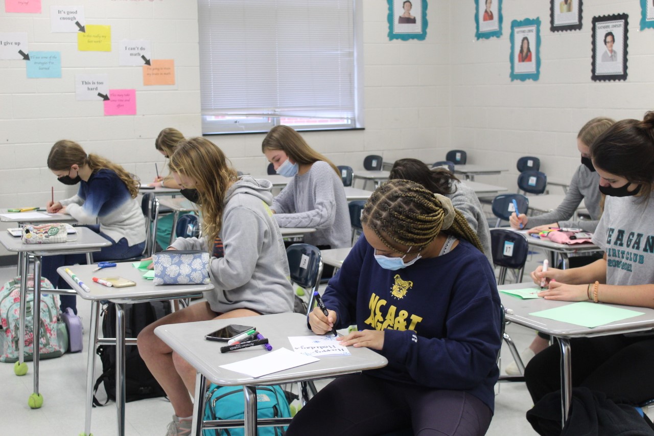 Members of the Reagan Girls Service Club gather in math teacher and club sponsor Janey Johnson’s room to work on creating holiday cards to distribute to nursing home residents. Johnson said nursing homes have been neglected during the pandemic and hopes to spread holiday cheer. 