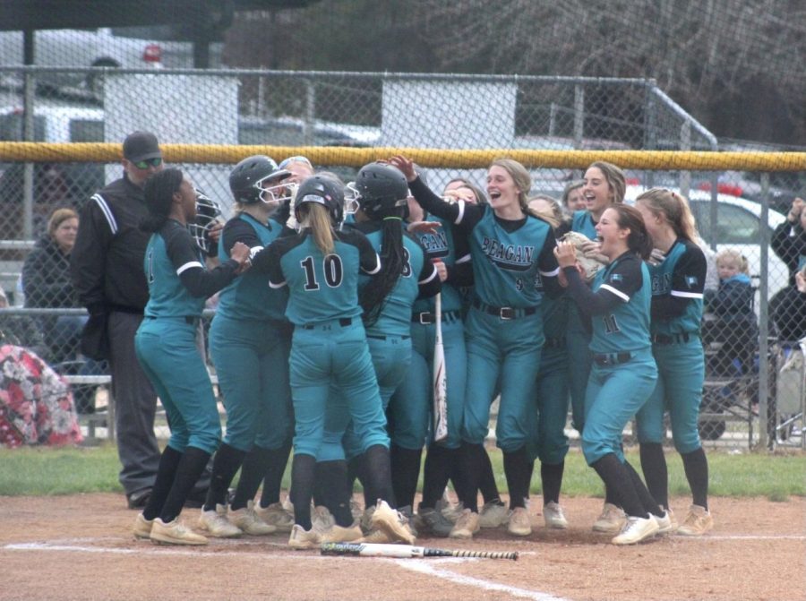 The varsity womens softball team celebrates senior Desiree Warners home run. Their teamwork and encouragement was displayed through out the game. 